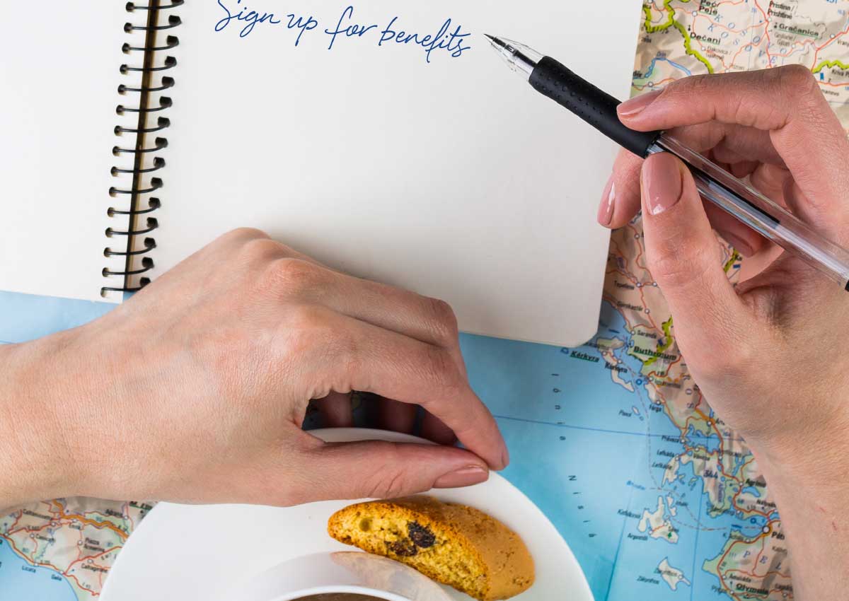 photo of person eating breakfast and writing a reminder to sign up for benefits